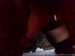 A woman pees and poops on the floor. Video is somewhat dark. Over a minute.